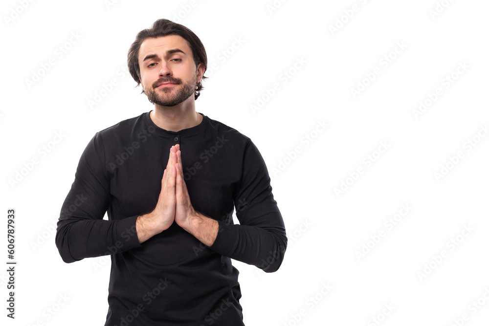 young handsome caucasian brunette man with beard in informal style praying young handsome caucasian brunette man with beard in informal style praying