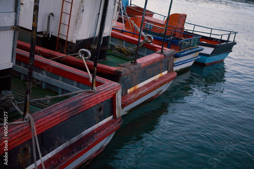 Details of small fishing and crayfishing trawlers moored in Lambert's Bay, harbor, Western Cape, South Africa, in the early evening.