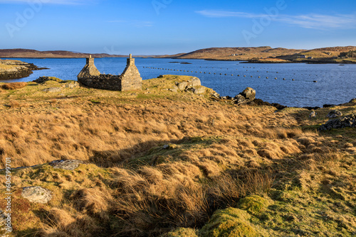 A ruined old croft house sits on the shore overlooking Loch Barraglom on the Isle of Lewis.