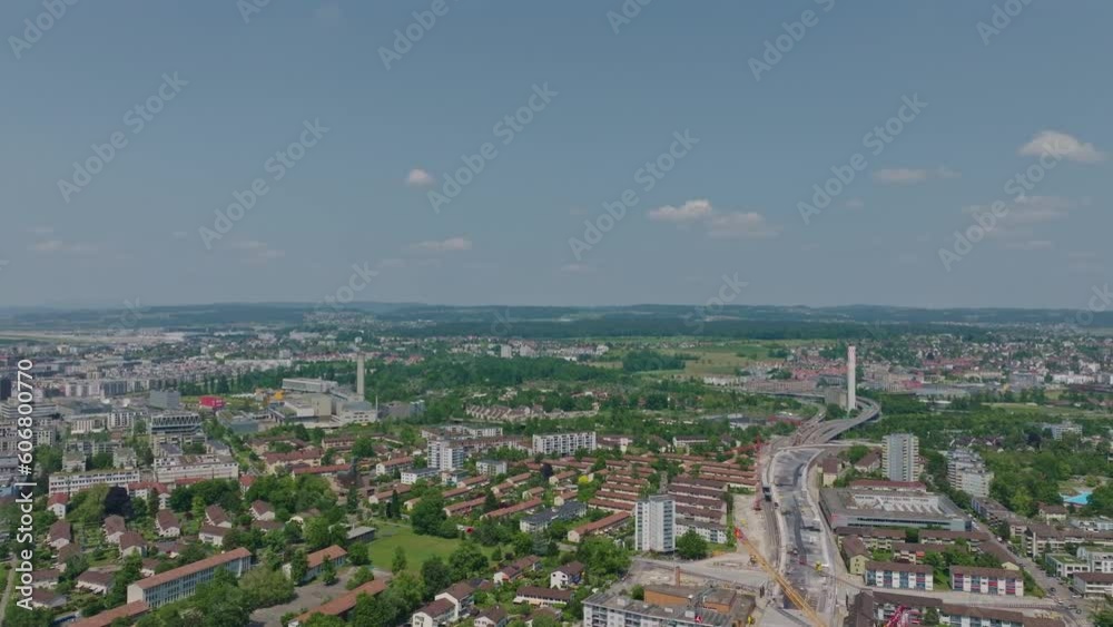 Aerial view of City of Zürich North with highway enclosure construction site and scenic landscape on a sunny spring day. Movie shot May 27th, 2023, Zurich, Switzerland. Aerial view of City of Zürich North with highway enclosure construction site and scenic landscape on a sunny spring day. Movie shot May 27th, 2023, Zurich, Switzerland.