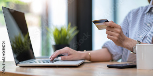 Online payment,Young woman's hands using computer and hand holding credit card for online shopping