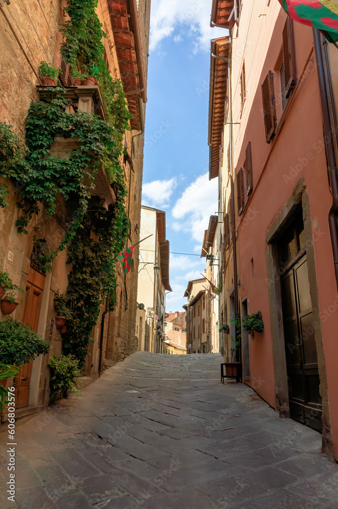 Street in historical center of Arezzo with facade of medieval buildings. Tuscany, Italy
