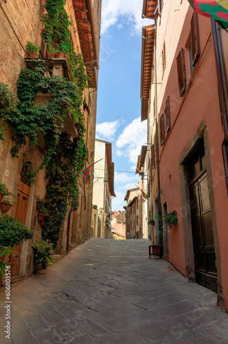 Street in historical center of Arezzo with facade of medieval buildings. Tuscany, Italy