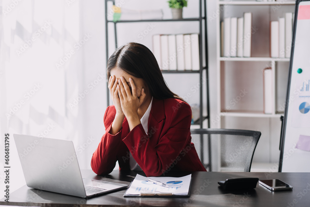 Asian women are stressed while working on laptop, Tired asian businesswoman with headache at office, feeling sick at work, copy space