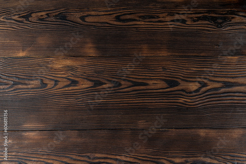 Beautiful wooden background. Burnt wood background. Wooden surface with a burnt pattern.