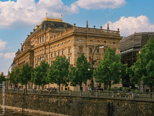 Prague, Czech Republic - may 26, 2019: The National Theatre in Prague, river Vltava, gold in water, reflection,