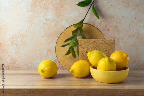Summer creative modern still life composition with lemons on wooden table photo
