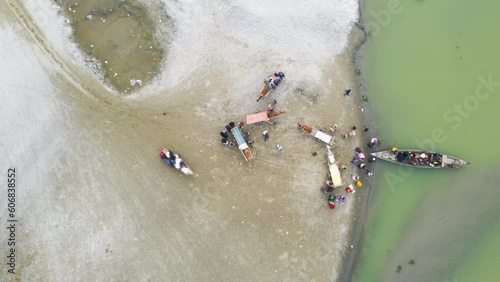 Drone view of People getting off boat and boarding horse-drawn carriages after crossing the Jamuna River, rural beauty of Bangladesh photo
