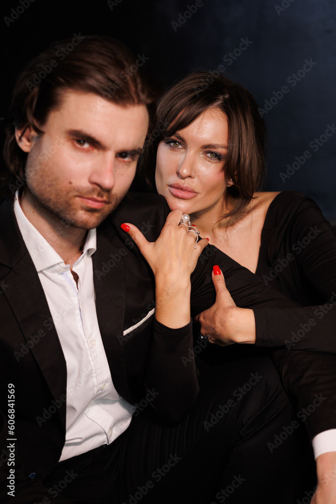 Gorgeous beautiful woman with a man touching each other. A lovely couple dressed in evening clothes. Wife and husband embrace and kiss passionately Gorgeous beautiful woman with a man touching each other. A lovely couple dressed in evening clothes. Wife and husband embrace and kiss passionately