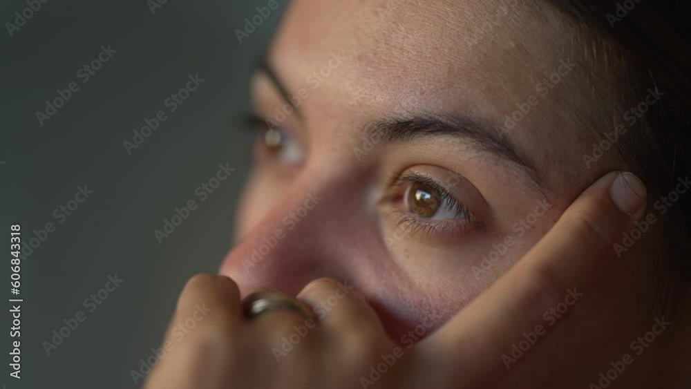 Closeup female 30s eyes in contemplation. Pensive thoughtful woman face closeup. Person pondering life in meditation