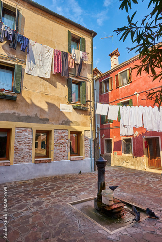 Typical city corner with ancient colorful buildings Drying clothes on a clothes-line in outdoor at sunny summer day. Venice