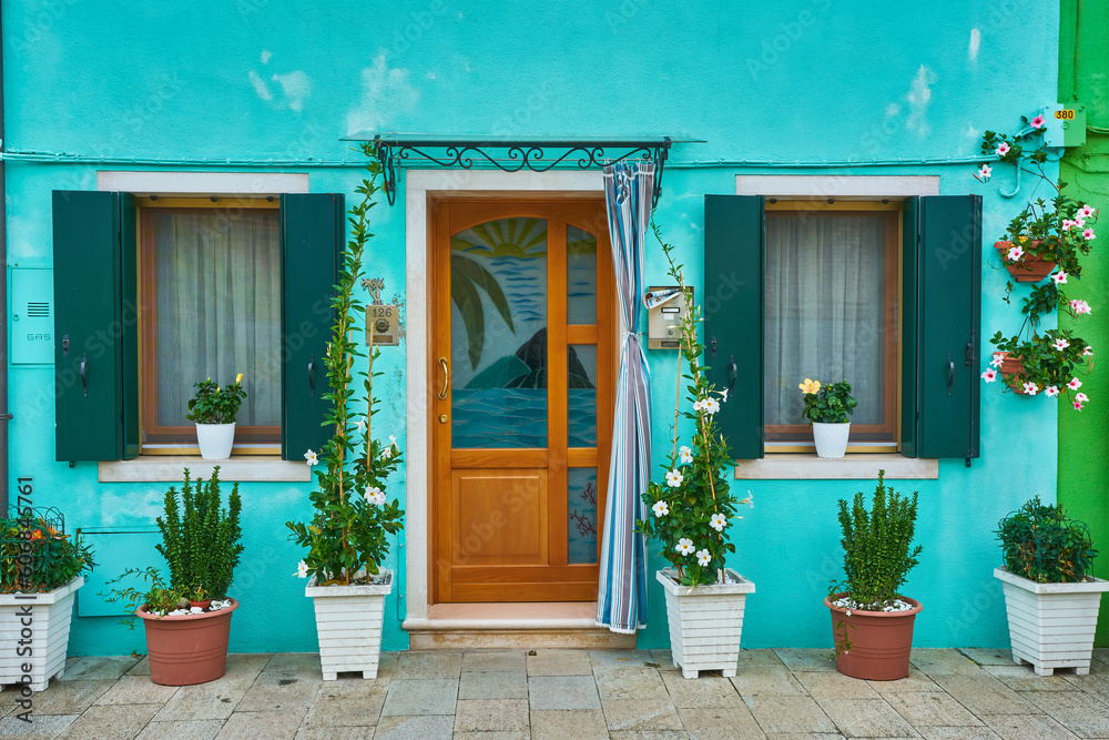 Blue facade of the house with door and windows. Colorful architecture in Burano.