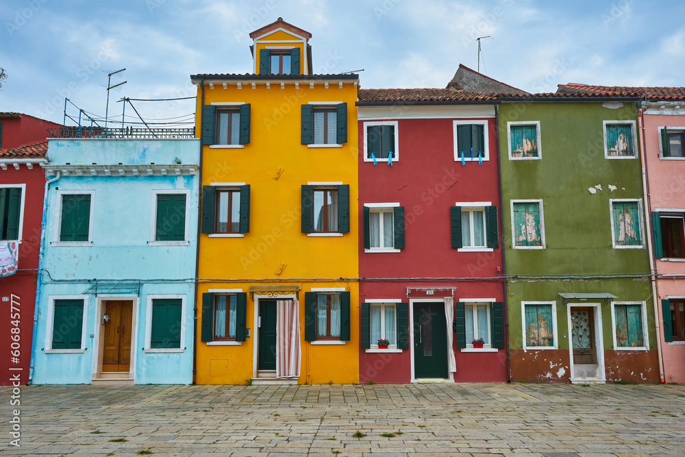 Picturesque walls with windows and door with shutters at the famous island Burano, Venice.