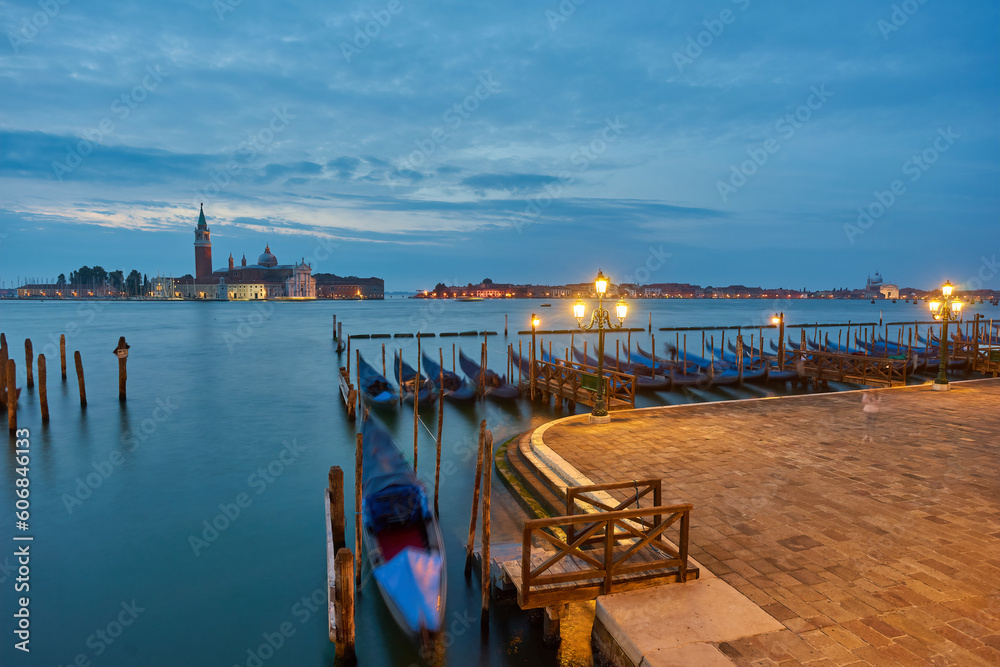 Obraz premium The most popular and romantic place in Venice. Gondolas moored at St. Mark's Square with the Church of San Giorgio di Maggiore in the background at sunset dawn, Venice.