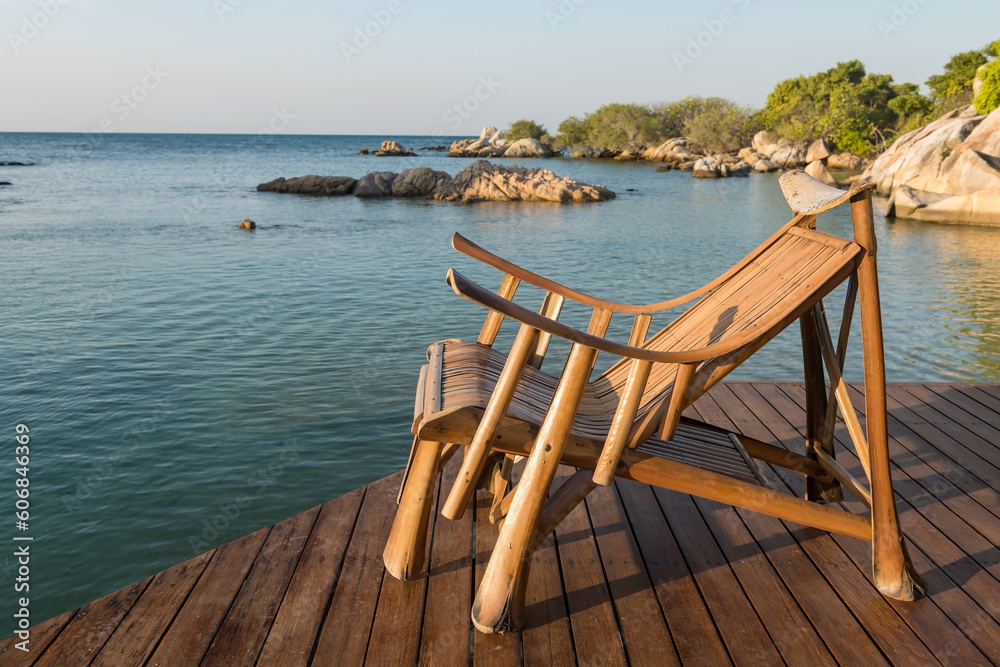 Wooden armchair at resort patio by sea, Ko Man Klang, Rayon Wooden armchair at resort patio by sea, Ko Man Klang, Rayon