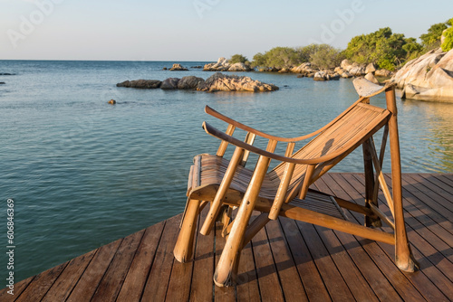 Wooden armchair at resort patio by sea, Ko Man Klang, Rayon © Blanscape