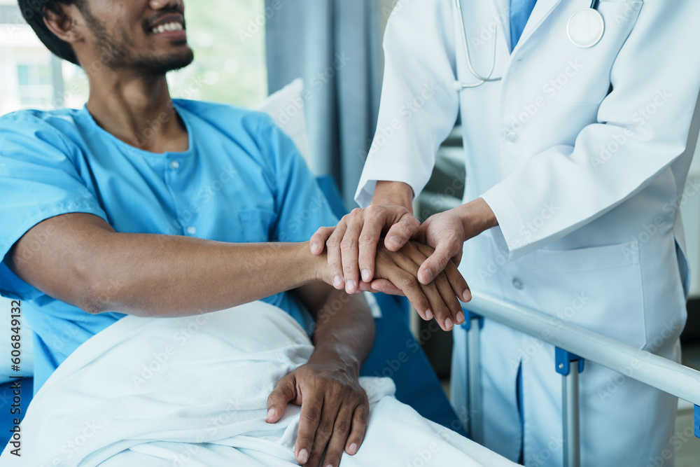 Obraz premium Hand of doctor reassuring his male patient. Medical ethics and trust concept.
