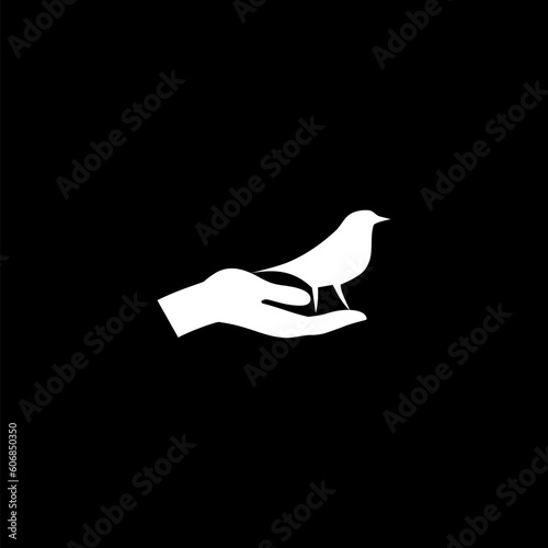 Hand and a bird icon isolated on black background photo