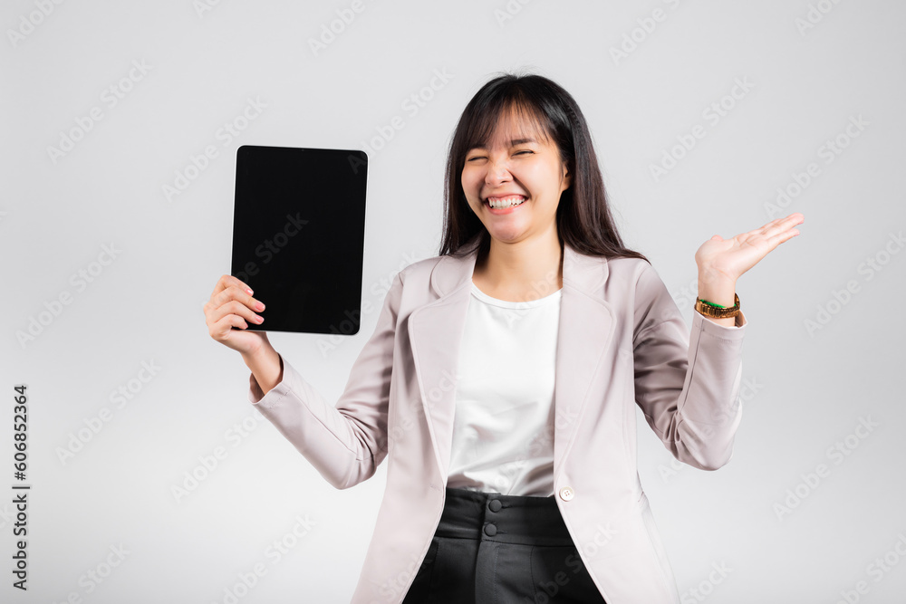 Asian beautiful young woman smiling using tablet computer, Happy female show blank screen digital tablet pc and presenting product with palm of hand at empty, studio shot isolated on white background Asian beautiful young woman smiling using tablet computer, Happy female show blank screen digital tablet pc and presenting product with palm of hand at empty, studio shot isolated on white background