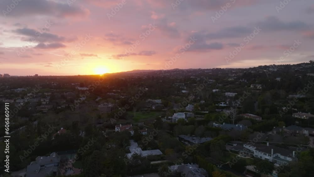 Aerial panoramic view of luxurious residential district with large residencies against romantic colourful sunset. Aerial panoramic view of luxurious residential district with large residencies against romantic colourful sunset.