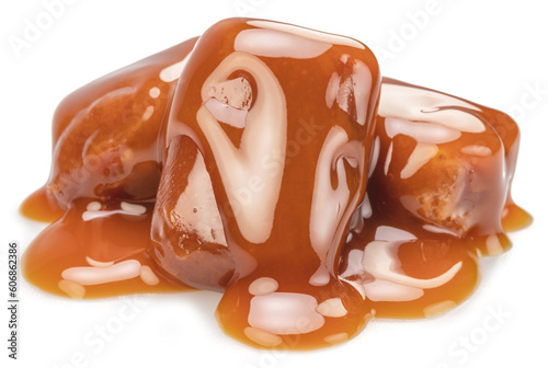 Caramel candies covered with melt caramel isolated on white background.