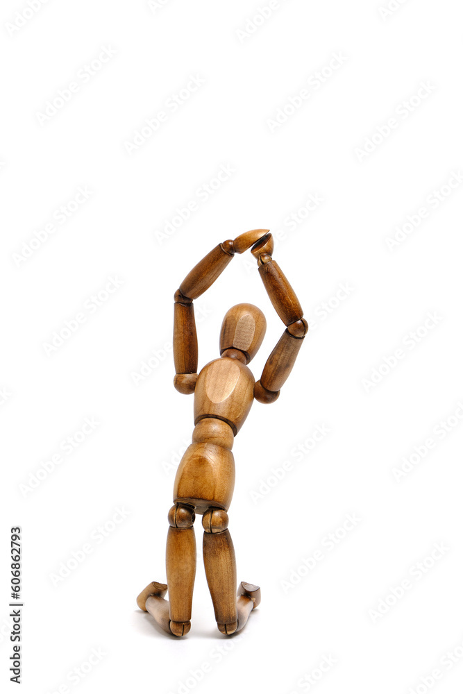 Figure wooden mannequin kneeling with his hands raised up. Figure wooden mannequin kneeling with his hands raised up.