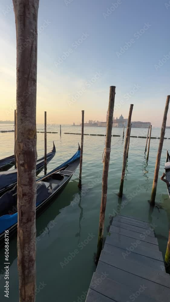 Vertical video of a beautiful sunrise in Venice, Italy where you can see the sea, the gondolas and old buildings. Vertical video of a beautiful sunrise in Venice, Italy where you can see the sea, the gondolas and old buildings.