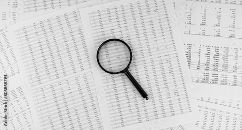 Magnifying glass on financial statement.