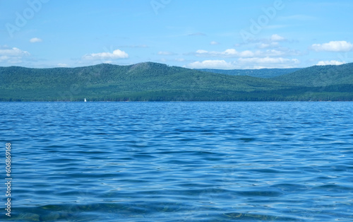 Beautiful summer landscape with big lake, blue sky with clouds, green mountains. abstract natural background. travel, adventure and vacation concept. relax time. Russia, South Ural, lake Turgoyak