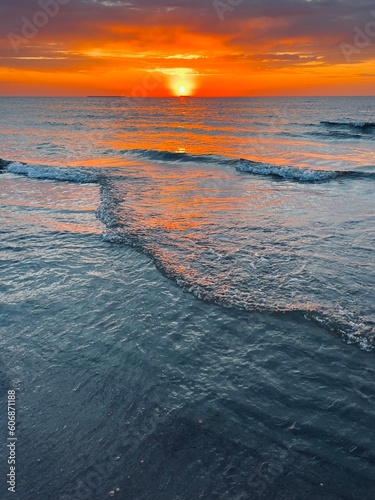 Fantastic orange sunset at the sea, natural colors of the sunset sky and sea water © Oksana