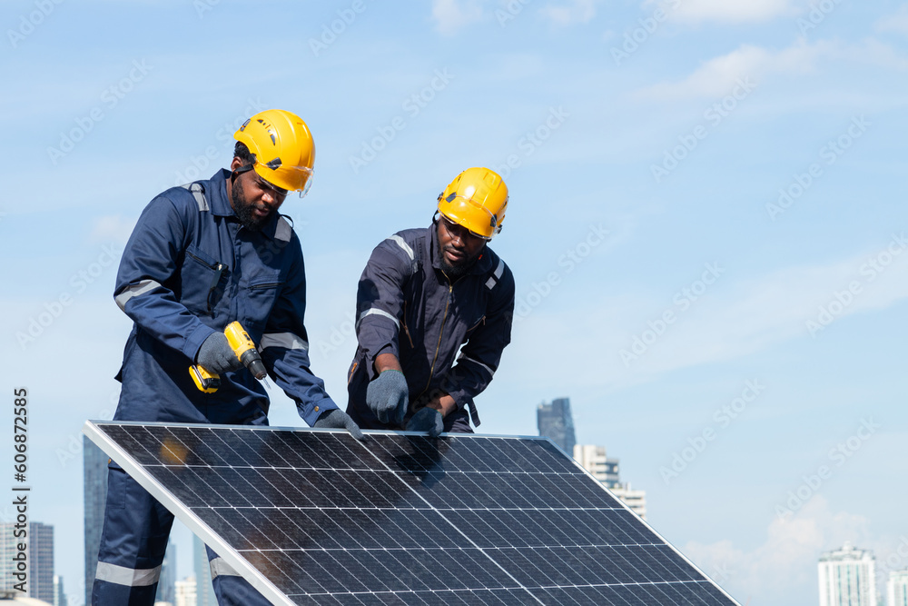 Engineers and technicians check drawings for installing solar cell panels on the roof. alternative energy energy from the sun Engineers and technicians check drawings for installing solar cell panels on the roof. alternative energy energy from the sun