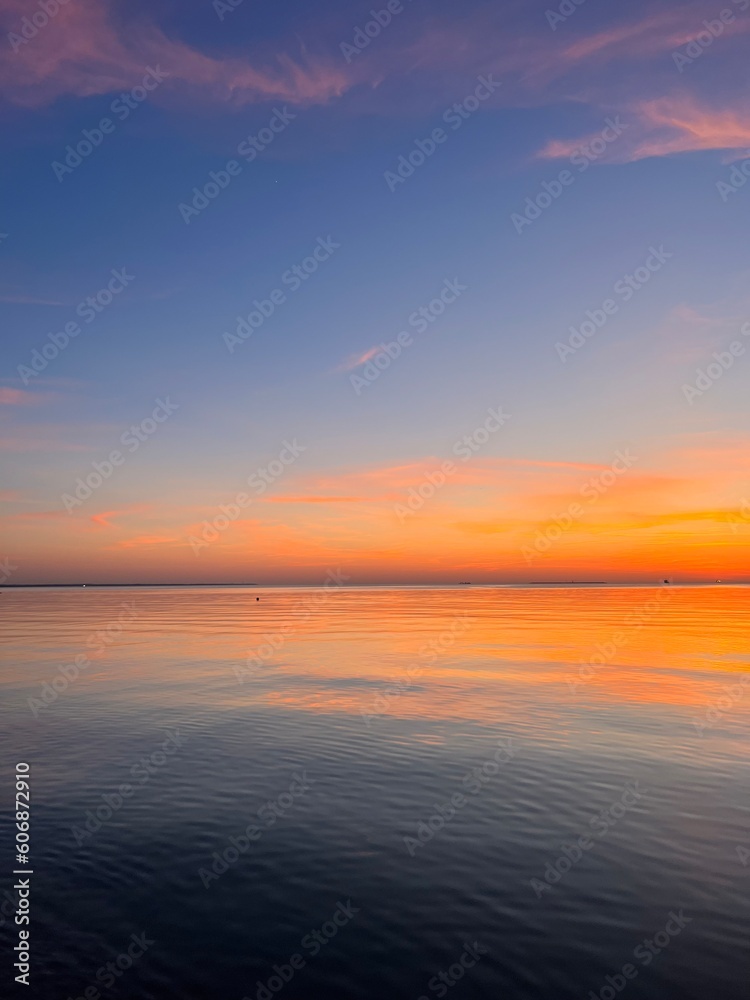 Orange sky after the sunset at the sea, evening sea horizon 