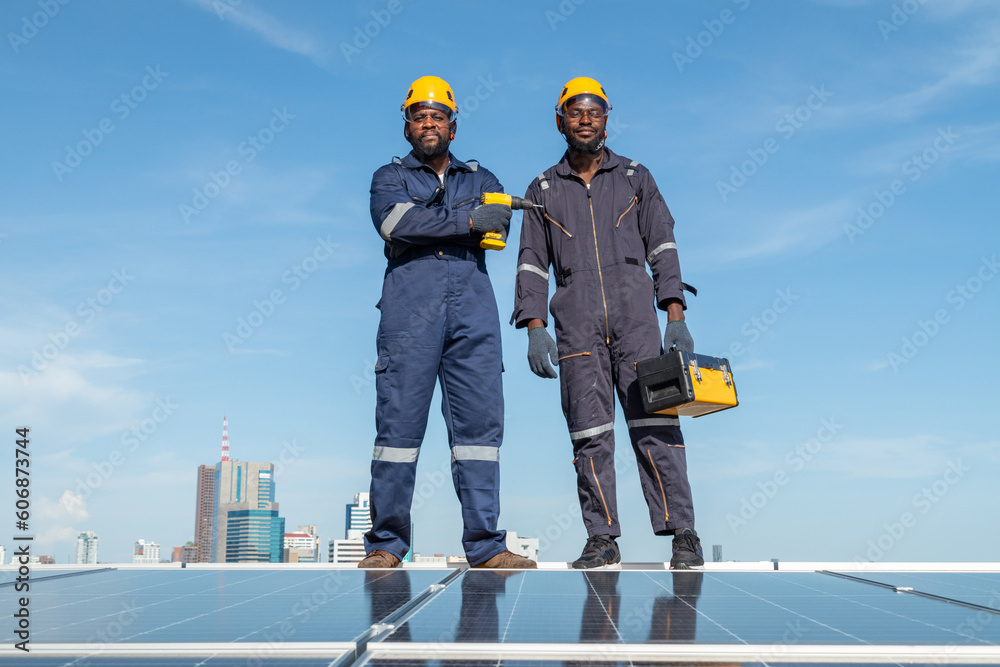 Engineers and technicians check drawings for installing solar cell panels on the roof. alternative energy energy from the sun Engineers and technicians check drawings for installing solar cell panels on the roof. alternative energy energy from the sun