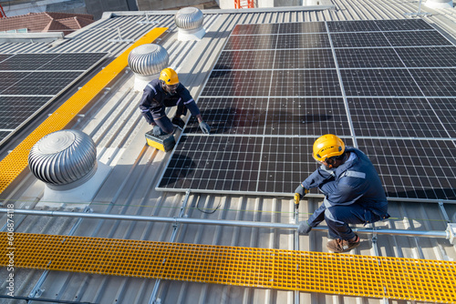 Wallpaper Mural Engineers and technicians check drawings for installing solar cell panels on the roof. alternative energy energy from the sun Torontodigital.ca