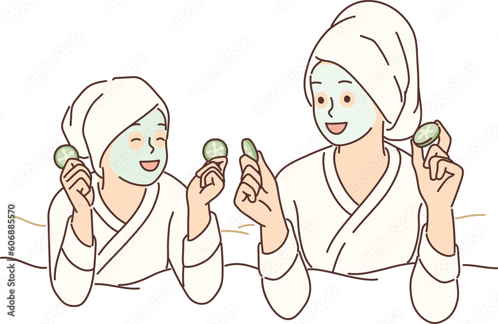 Two girls with hygienic mask on face rest lying on bed during rejuvenating spa treatment Two girls with hygienic mask on face rest lying on bed during rejuvenating spa treatment