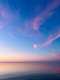 Tender bright seascape after the sunset, blue and pink sky and sea surface