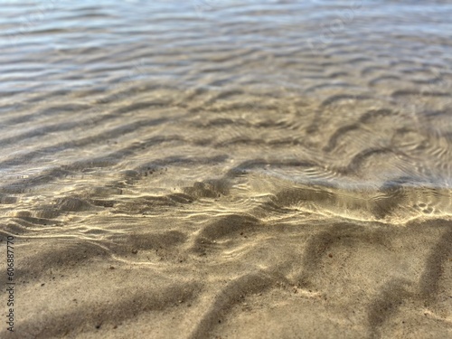 Transparent sea water and sandy bottom  ripples on the sea water  natural sea water background