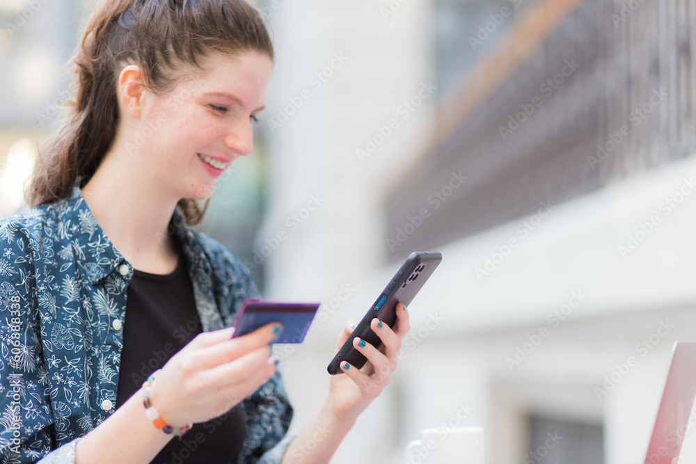 happy Young woman using credit card and smartphone, online payments concept happy Young woman using credit card and smartphone, online payments concept