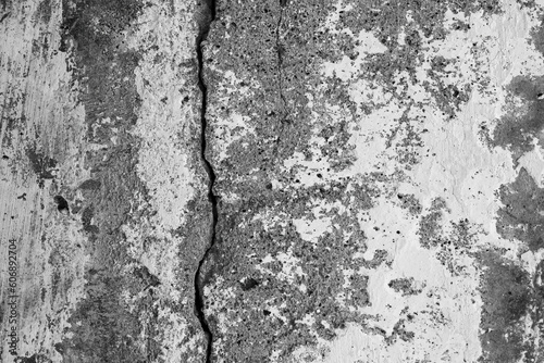 Texture of an old cracked concrete wall. Rough gray concrete surface. The gap between the reinforced concrete slabs. Perfect for background and design. Close-up. High resolution.
