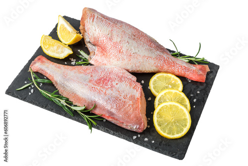 Fresh fish sebastes and ingredients for cooking. Raw gutted fish with spices and herbs on black slate isolated