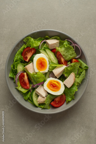 vegetable salad with an egg on a gray background