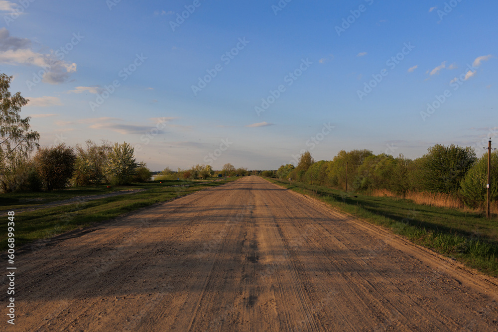 Fototapeta premium Beautiful rural road in the countryside, day landscape