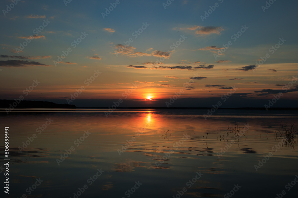 Evening landscape, sunrise or sunset on the lake or the sea