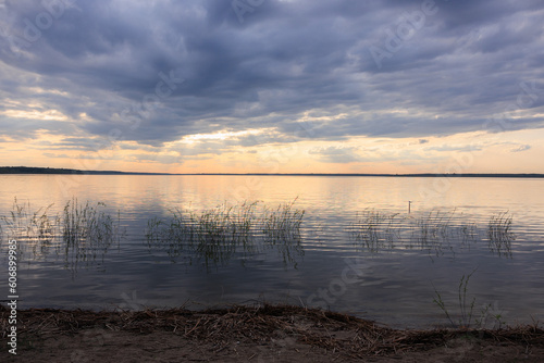 Evening landscape, sunrise or sunset on the lake or the sea