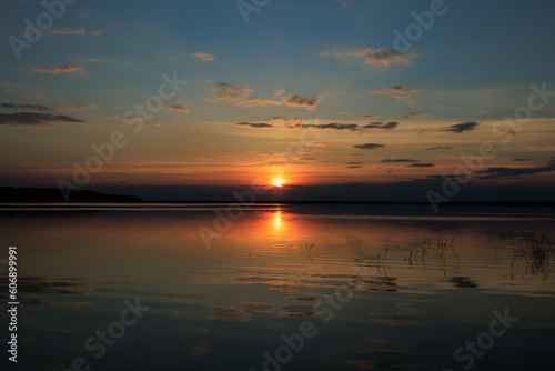 Evening landscape, sunrise or sunset on the lake or the sea