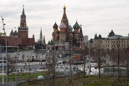 St Basil's Cathedral, the Kremlin on Moscow's Red Square. People, pedestrians, waiting buses, trees without leaves. The beginning of spring in Moscow.