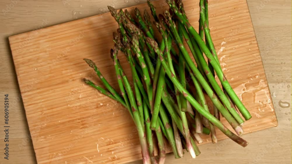 Asparagus falls on the board. Filmed is slow motion 1000 fps. High quality FullHD footage Asparagus falls on the board. Filmed is slow motion 1000 fps. High quality FullHD footage