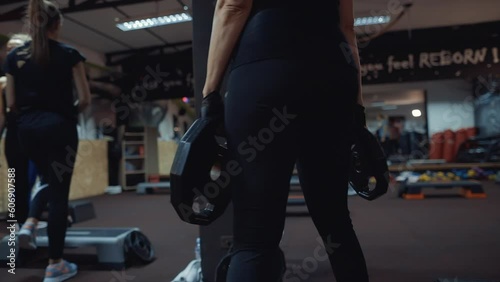 sportive women fitness exercising group workout. weight fitness plates in gym. Fitness background