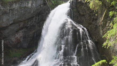 Waterfall cascade over mossy mountain rocks in the Alps. Gollinger Waterfall in Golling an der Salzach near Salzburg, Austria. Stunning view of wild nature. long exposure shot with slow shutter speed. photo