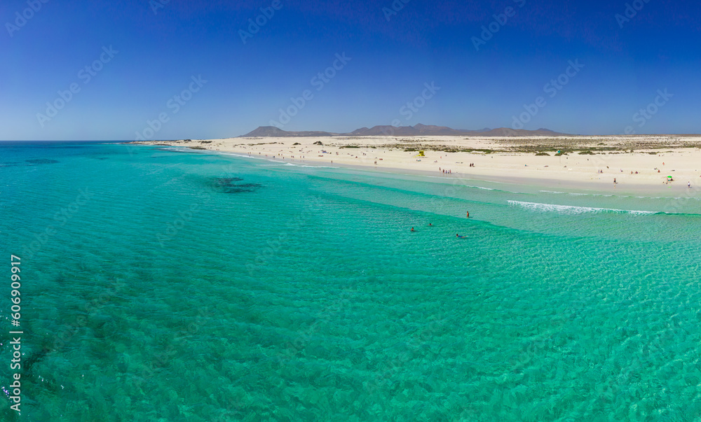 Beautiful mid level aspect aerial panoramic view of Grandes Playa beach with clear turquoise water near Corralejo in Fuerteventura Spain